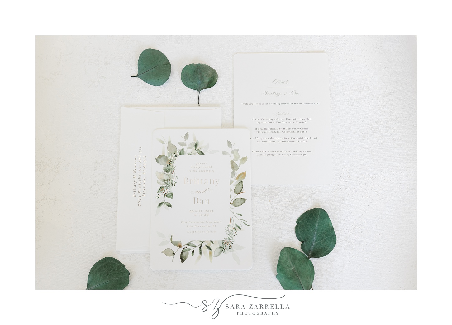 green and white invention suite with small leaves laying on white backdrop