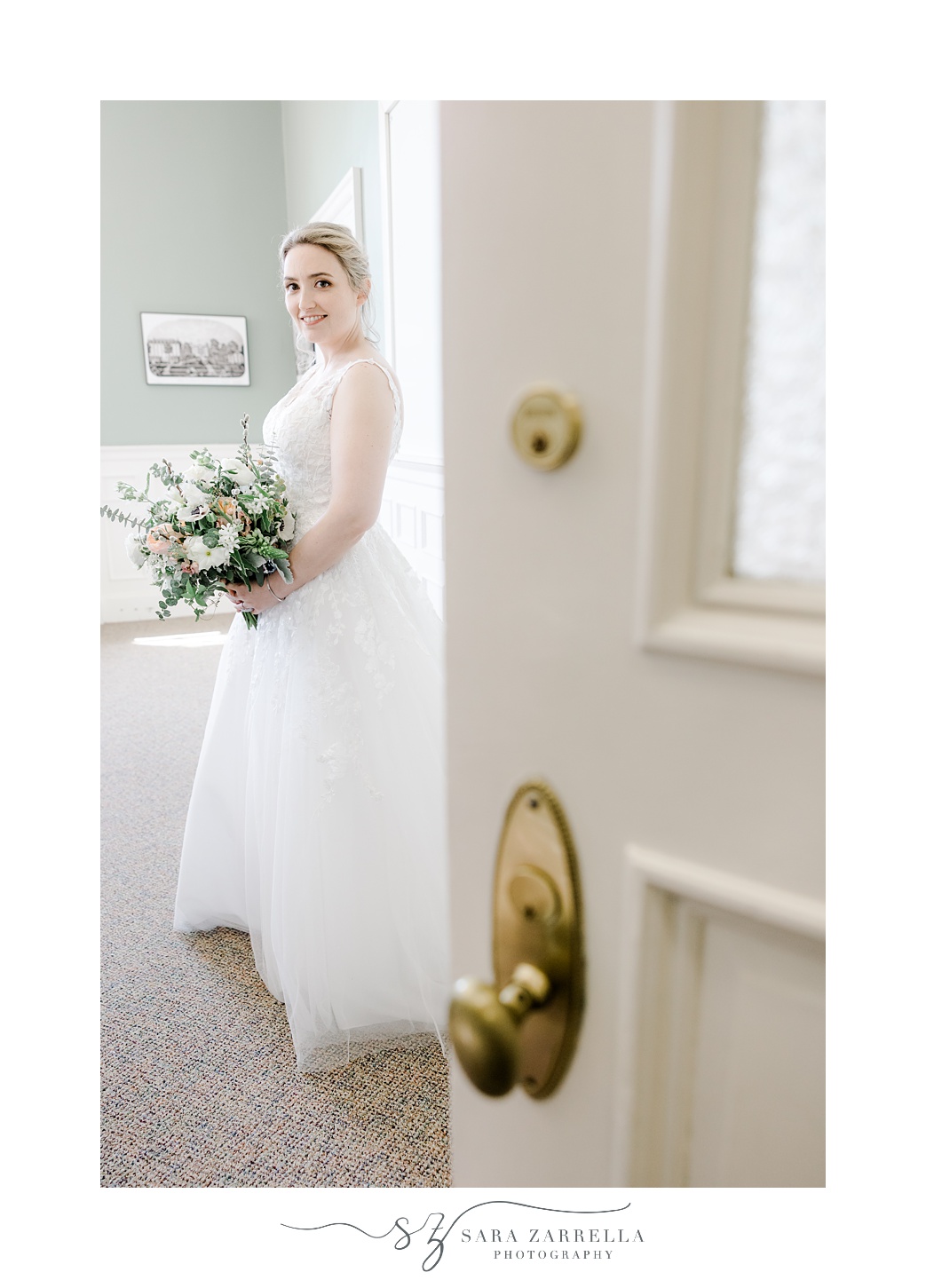 bride stands behind open door in East Greenwich Town Hall