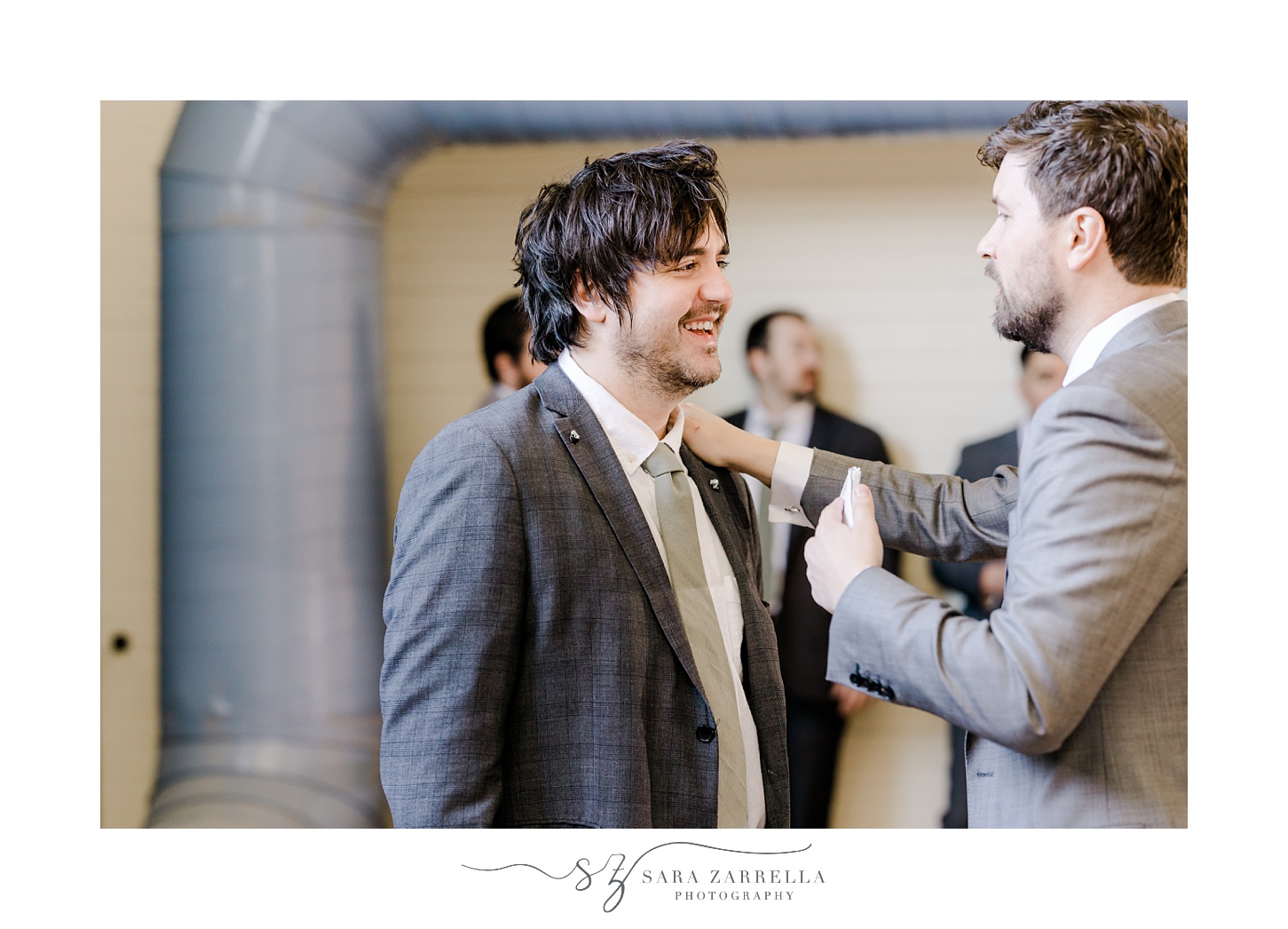 groom and groomsmen adjust ties before East Greenwich Town Hall wedding