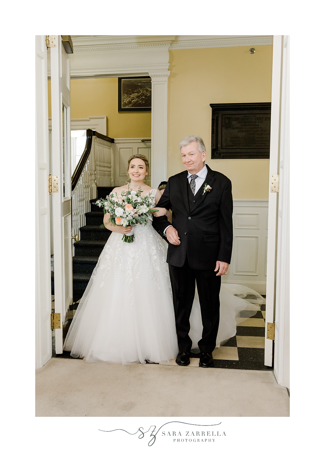 bride and father walk into ceremony in town hall