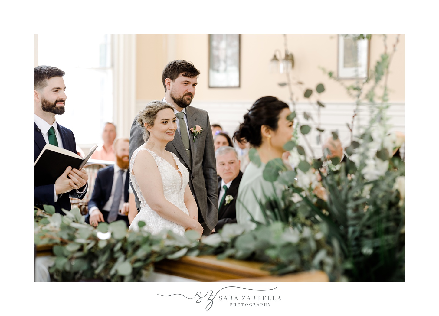 bride and groom listen to presentation during wedding ceremony in town hall