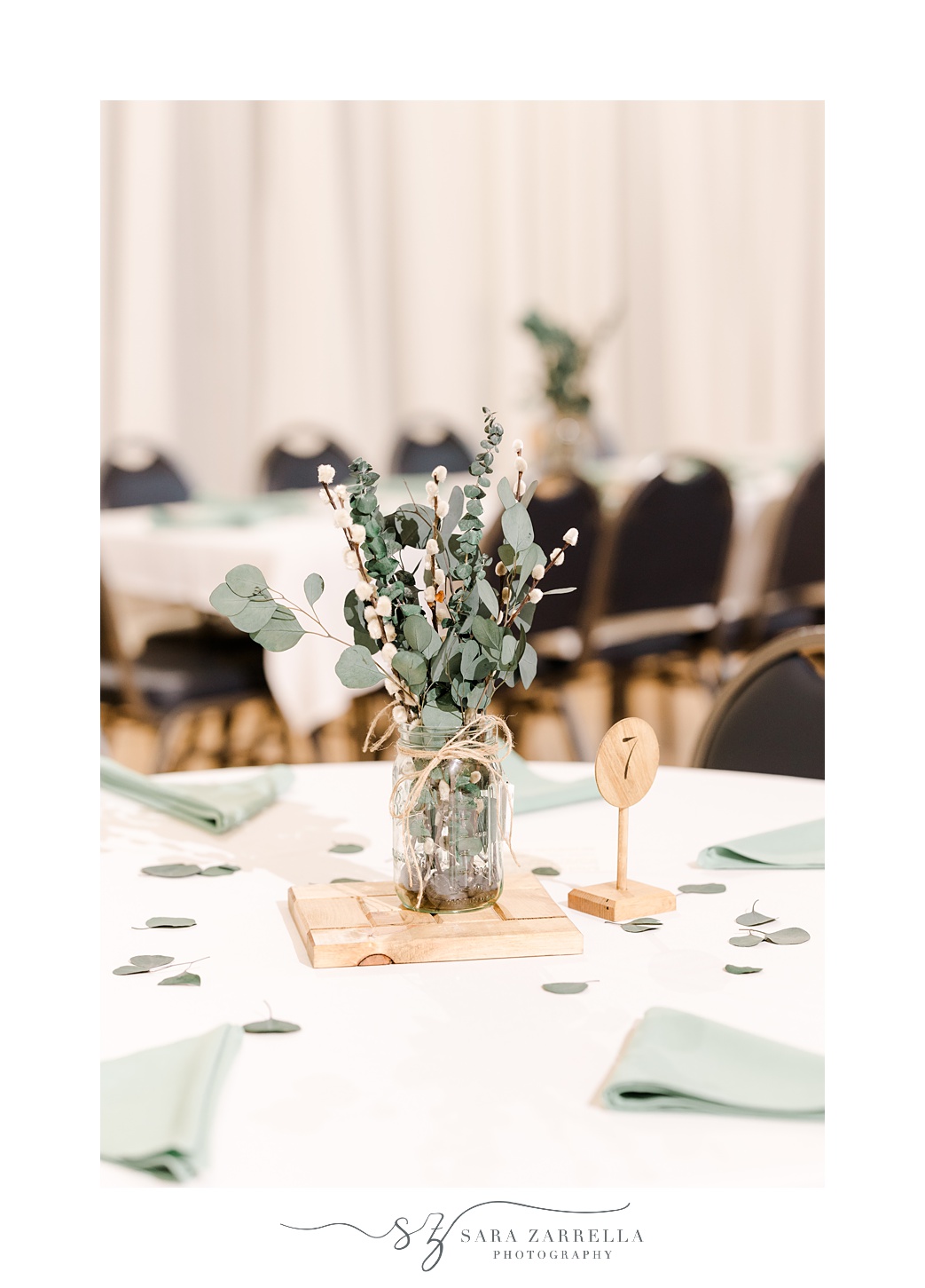 centerpiece with eucalyptus and sage green napkins at East Greenwich Town Hall
