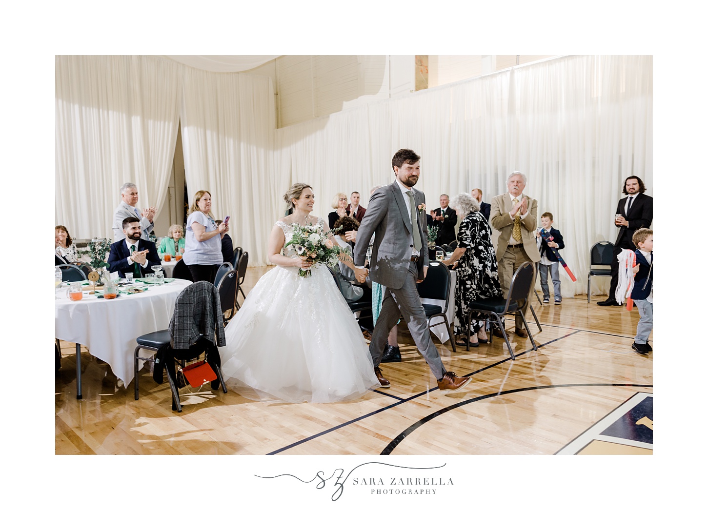 groom leads bride to dance floor during Greenwich RI wedding reception