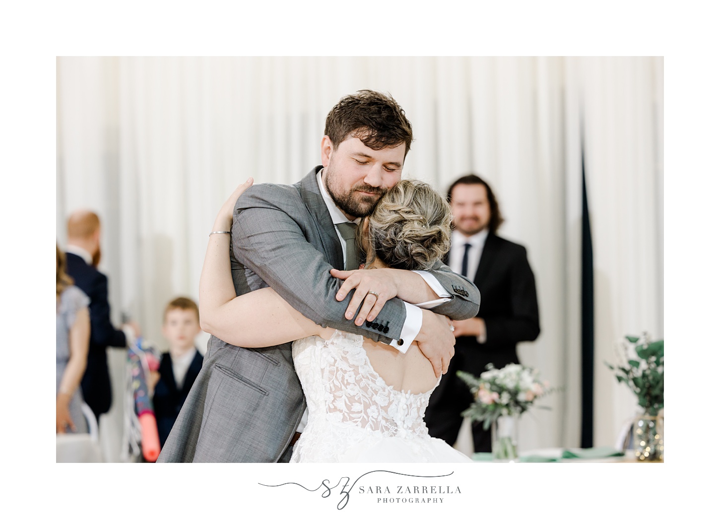 groom hugs bride after first dance at Greenwich RI wedding reception