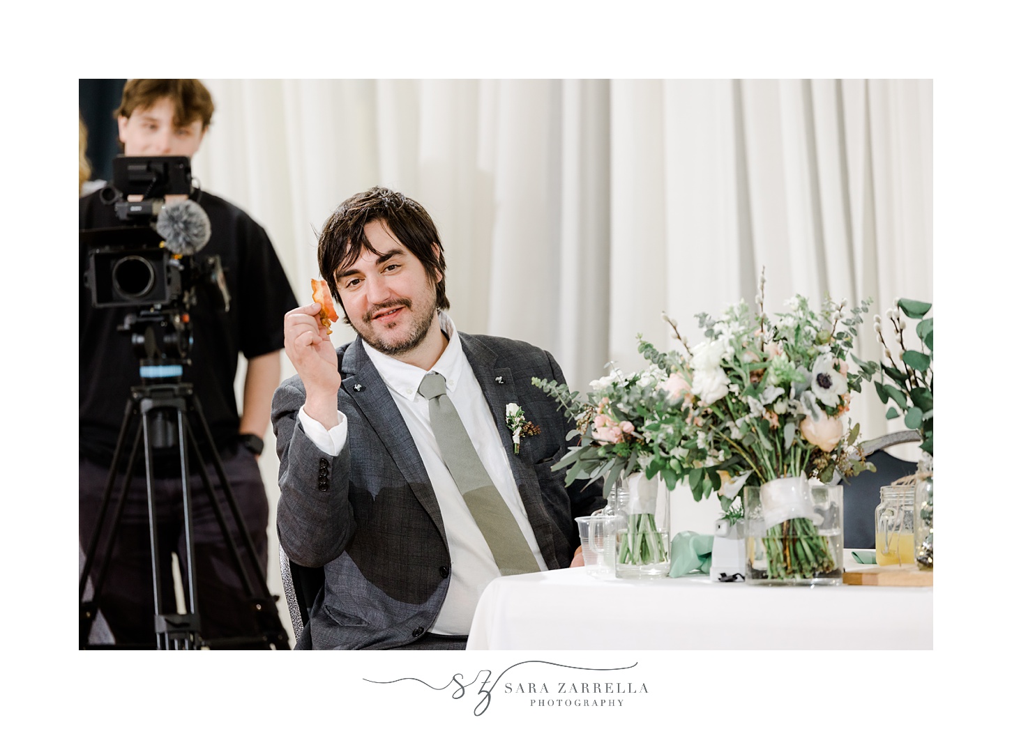 groom plays with figurine during reception 
