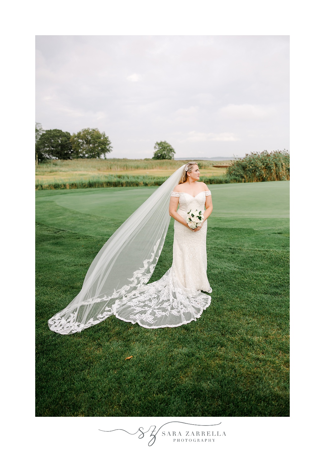 bride holds bouquet of white flowers on lawn at Quidnessett Country Club