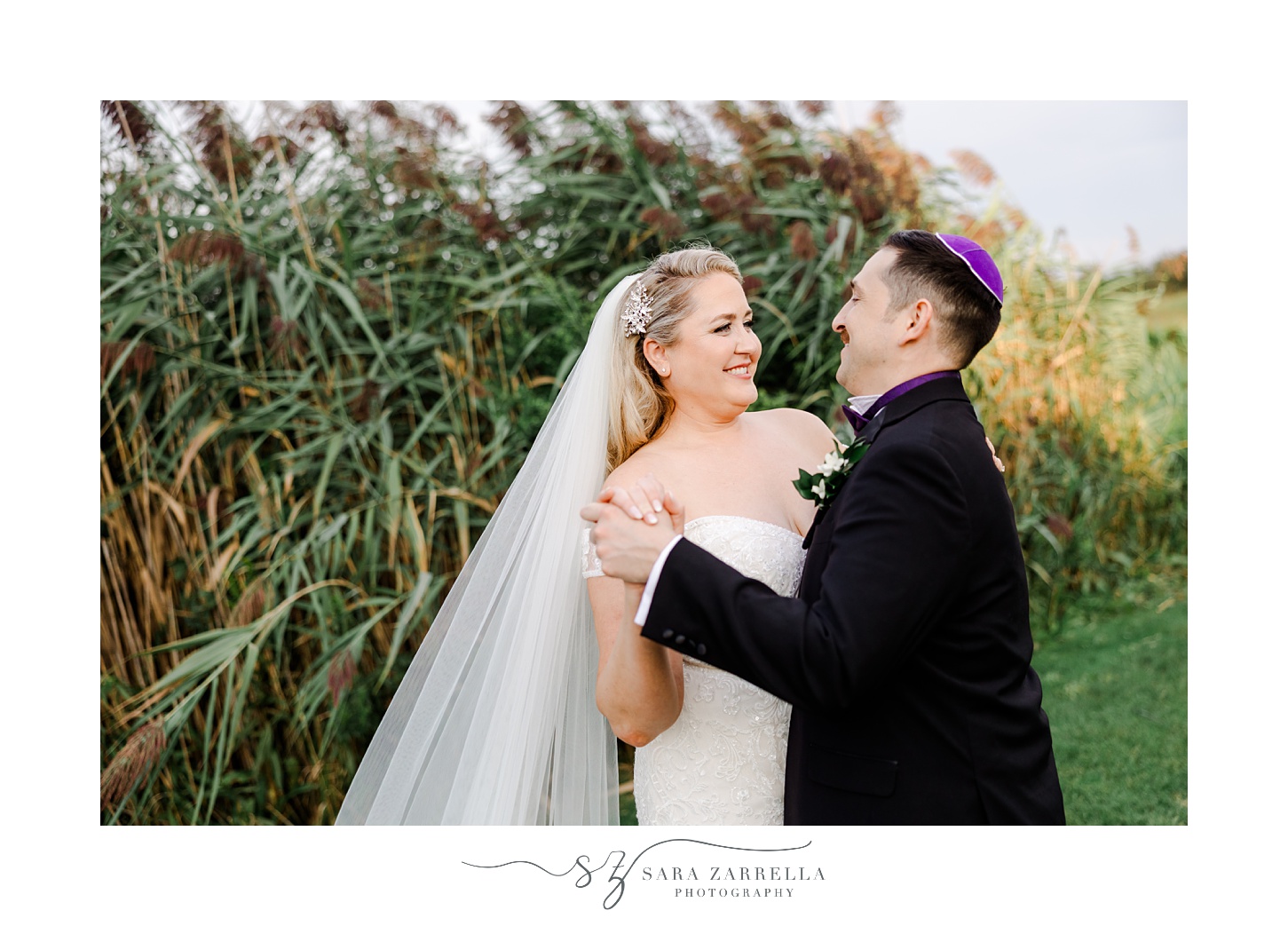 bride and groom dance near tall reeds at Quidnessett Country Club