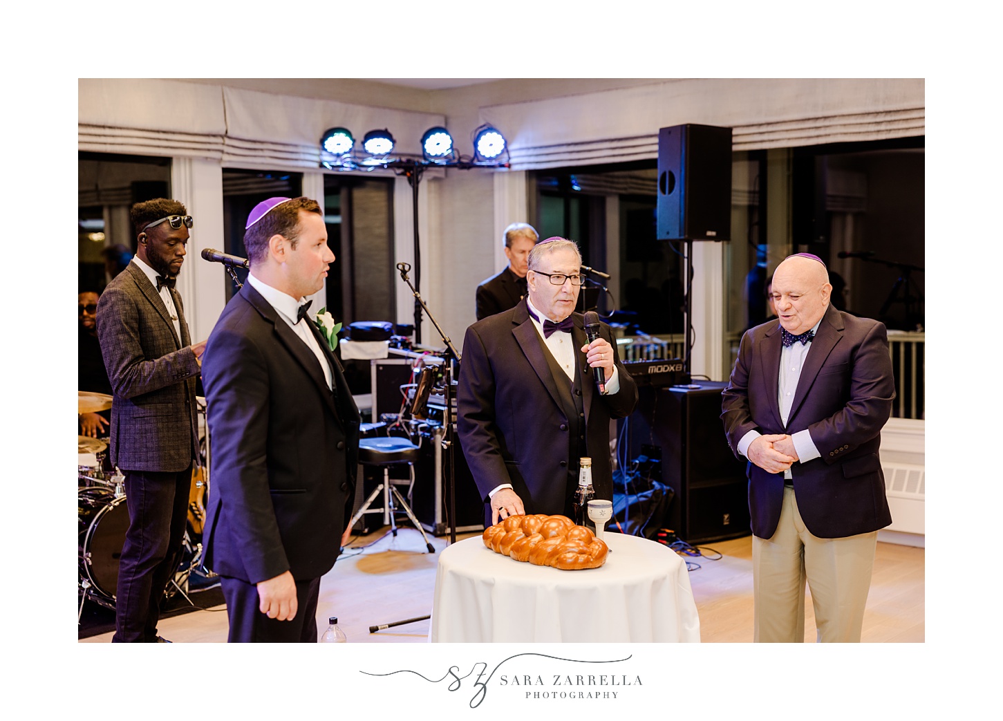 man gives speech and blesses challah during reception