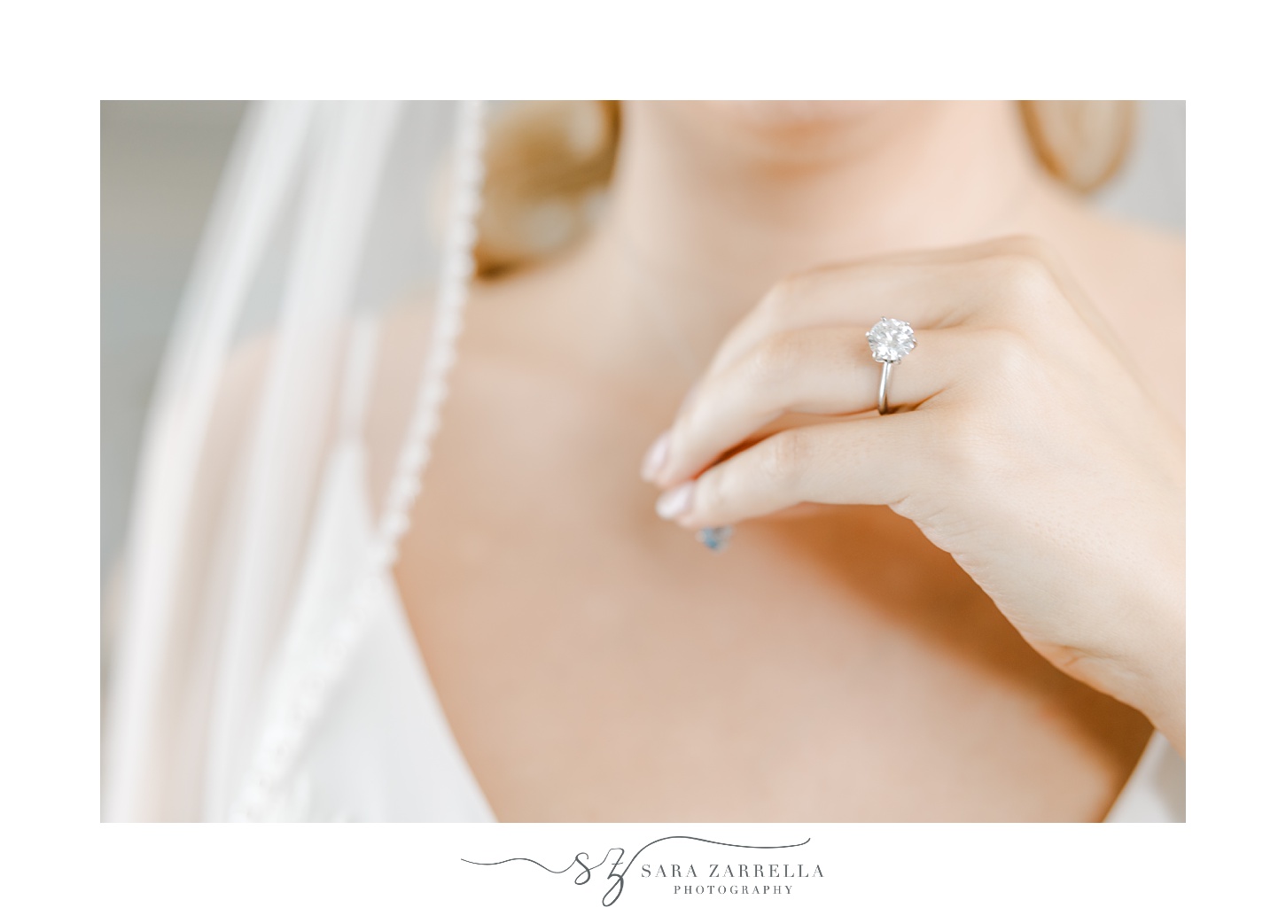 bride holds necklace showing off diamond ring