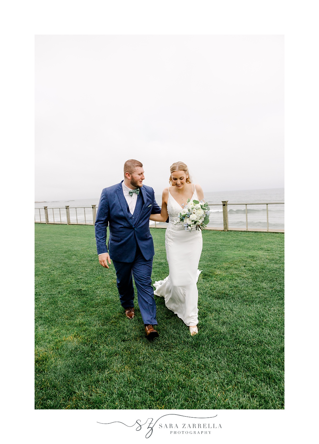 newlyweds hold hands walking together outside the Dunes Club