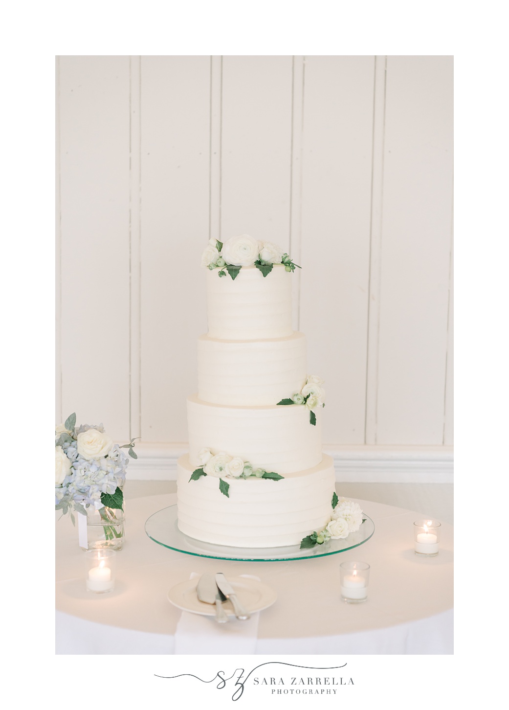 tiered wedding cake with white and blue flowers