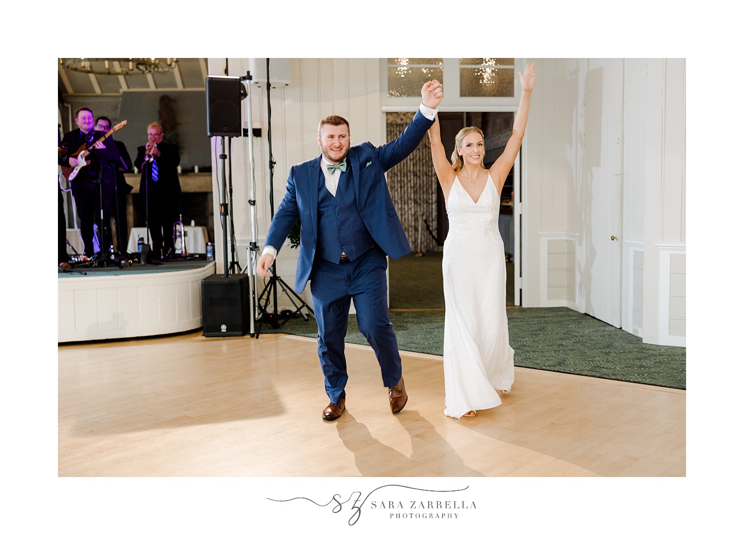 bride and groom cheer walking into wedding reception at the Dunes Club