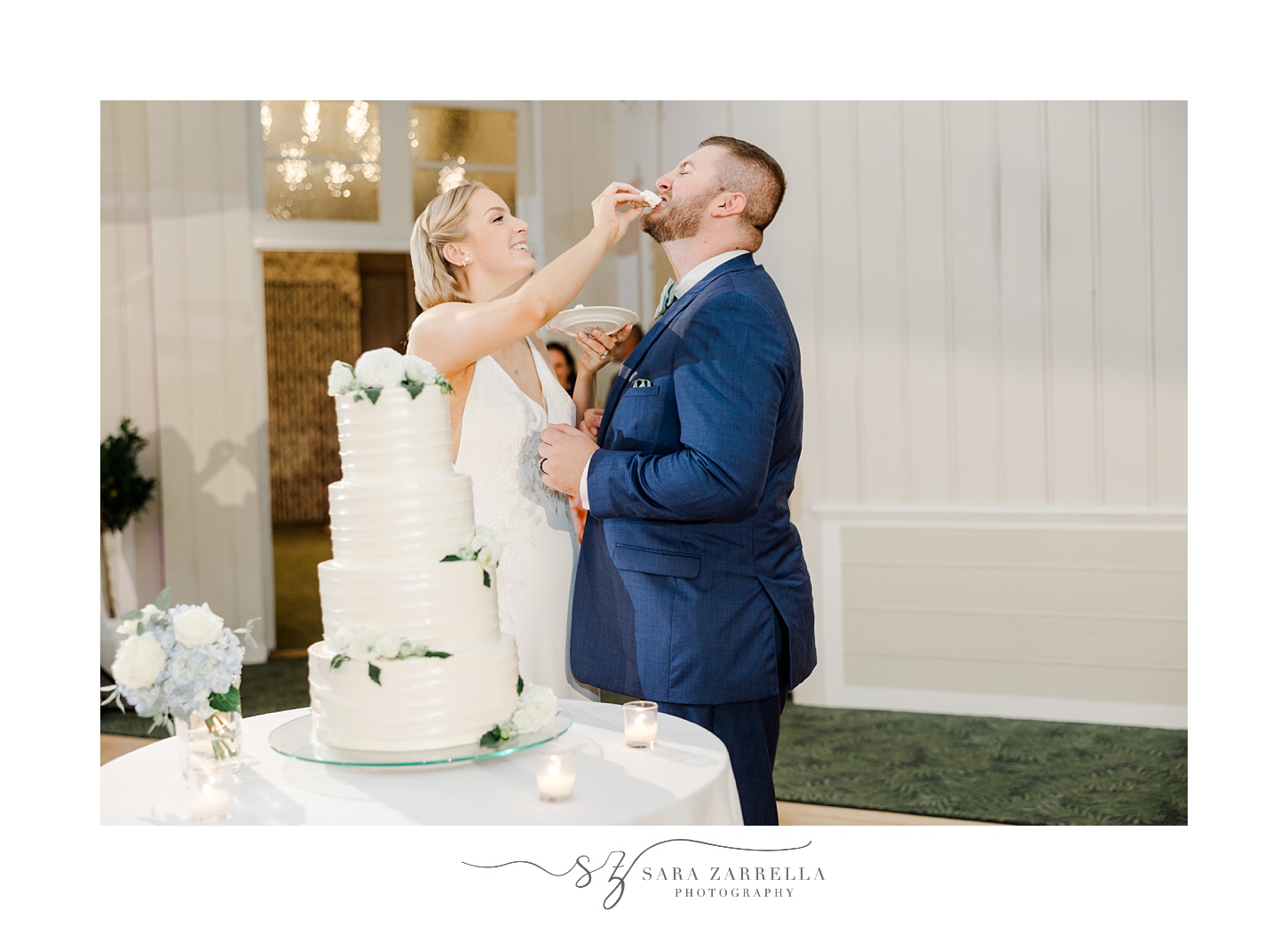 bride and groom slice cake feeding each other at wedding reception at the Dunes Club