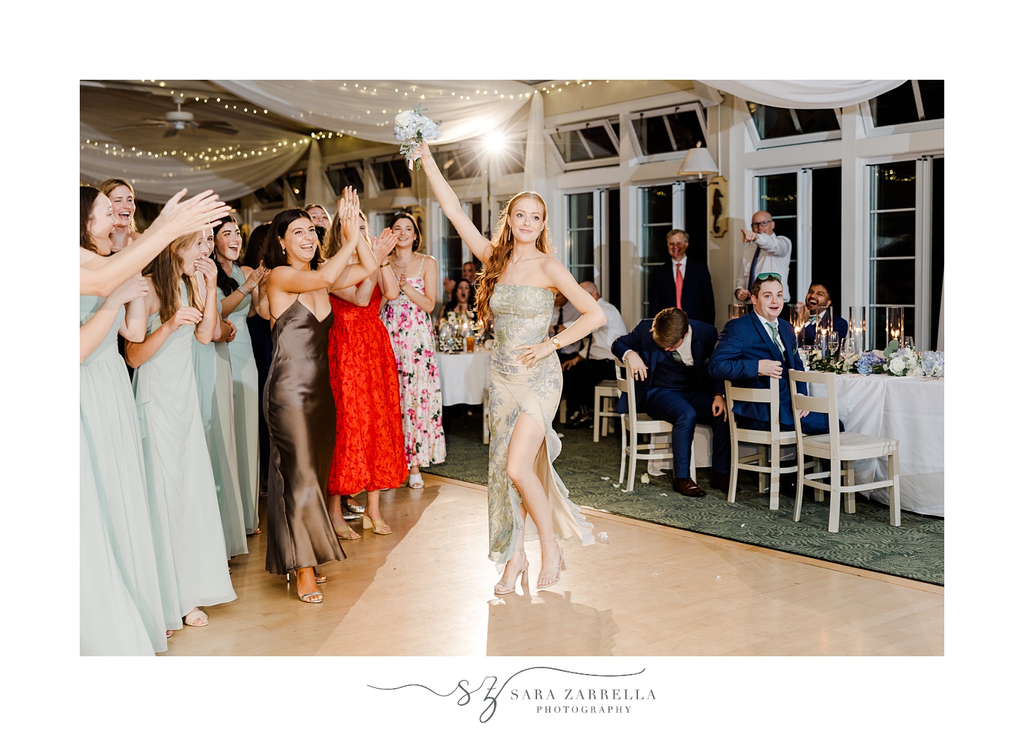 woman poses on dance floor with bouquet during wedding reception at the Dunes Club