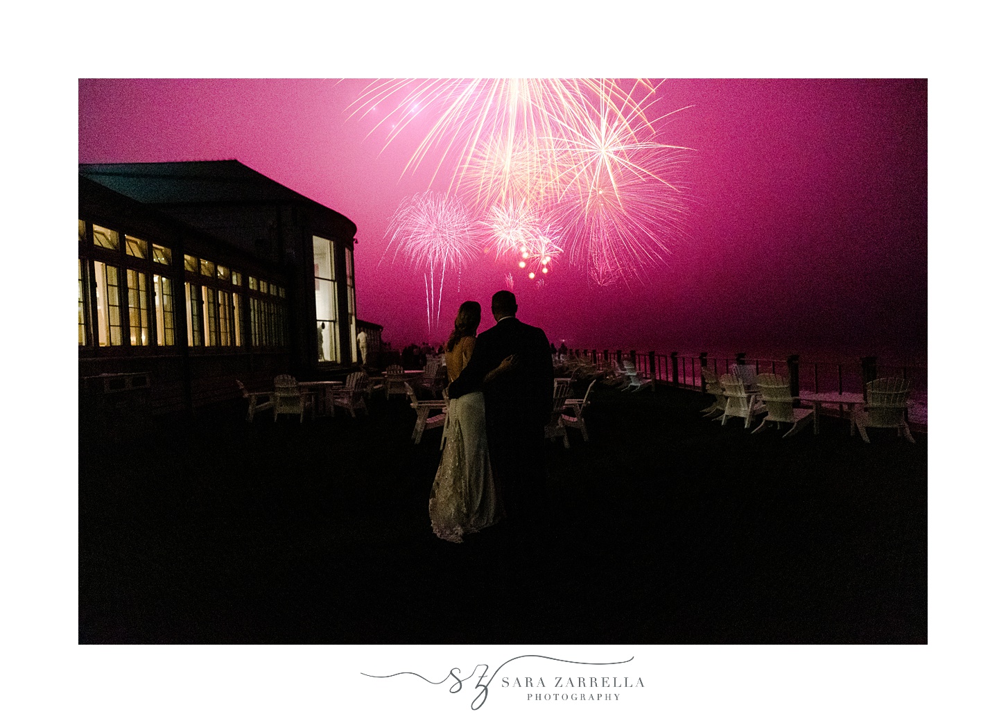 bride and groom hug watching fireworks outside the Dunes Club