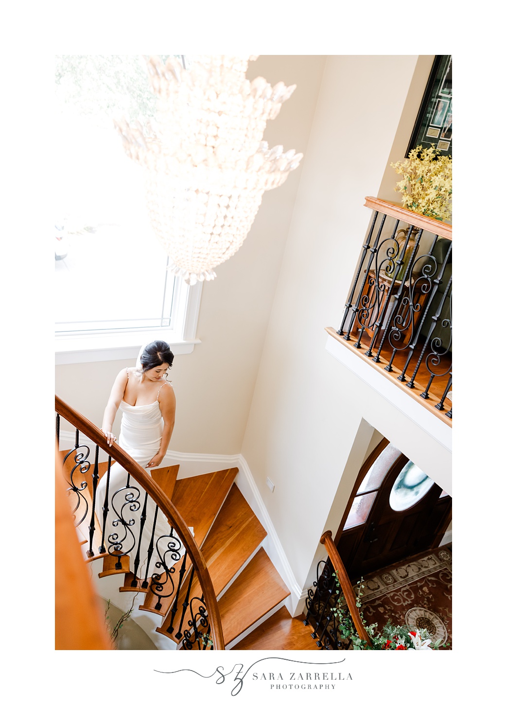 bride poses on spiral staircase in Cranston RI home