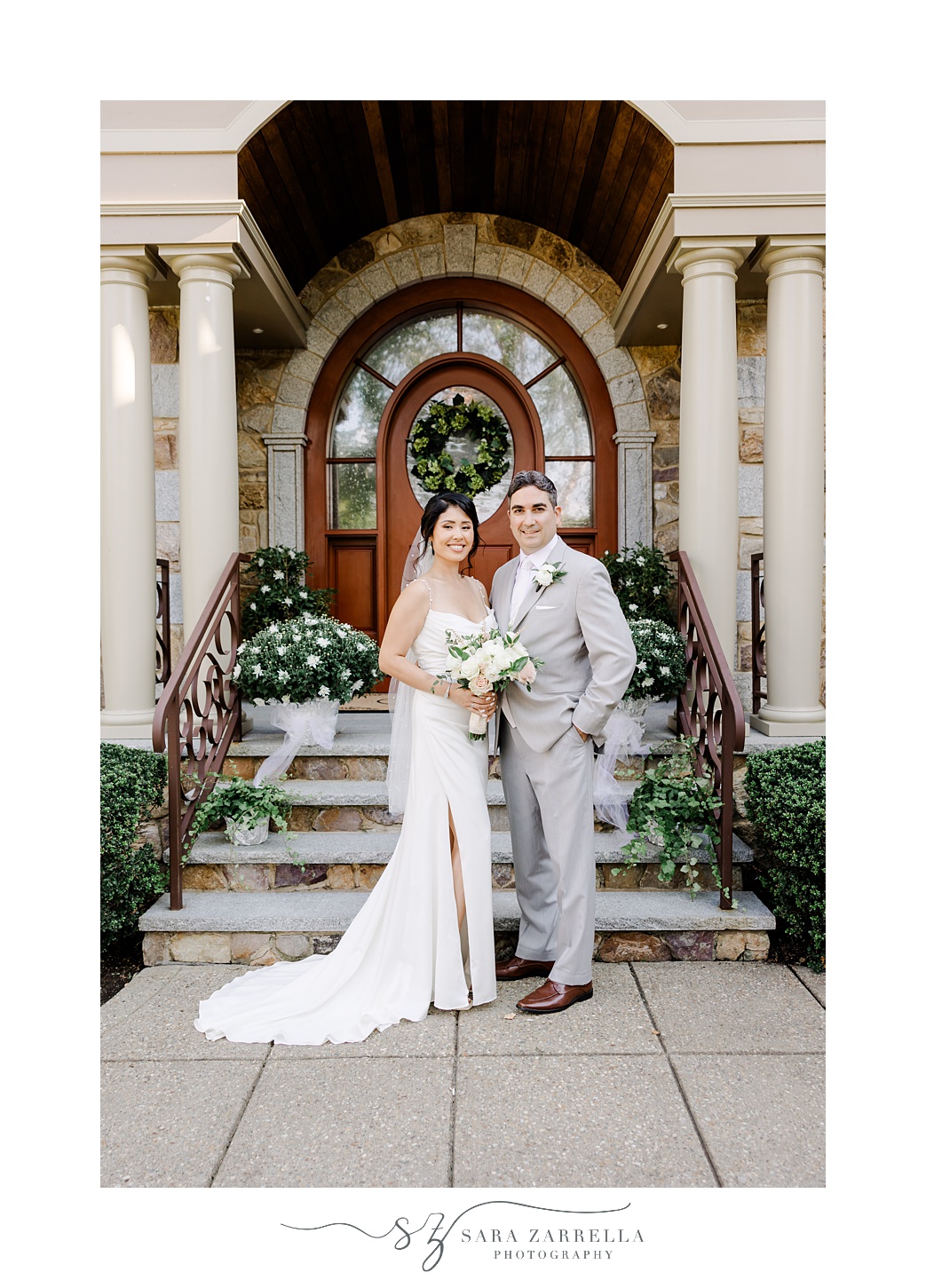 couple stands in front of front porch outside of Cranston RI home