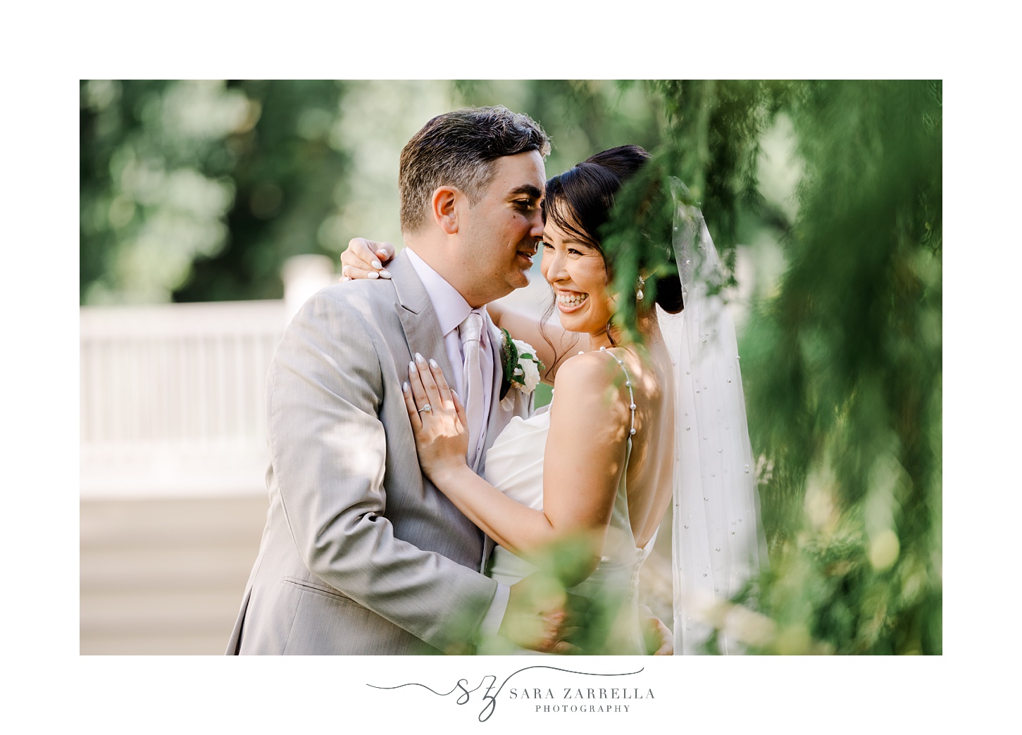bride and groom laugh during wedding portraits in backyard of Cranston RI home