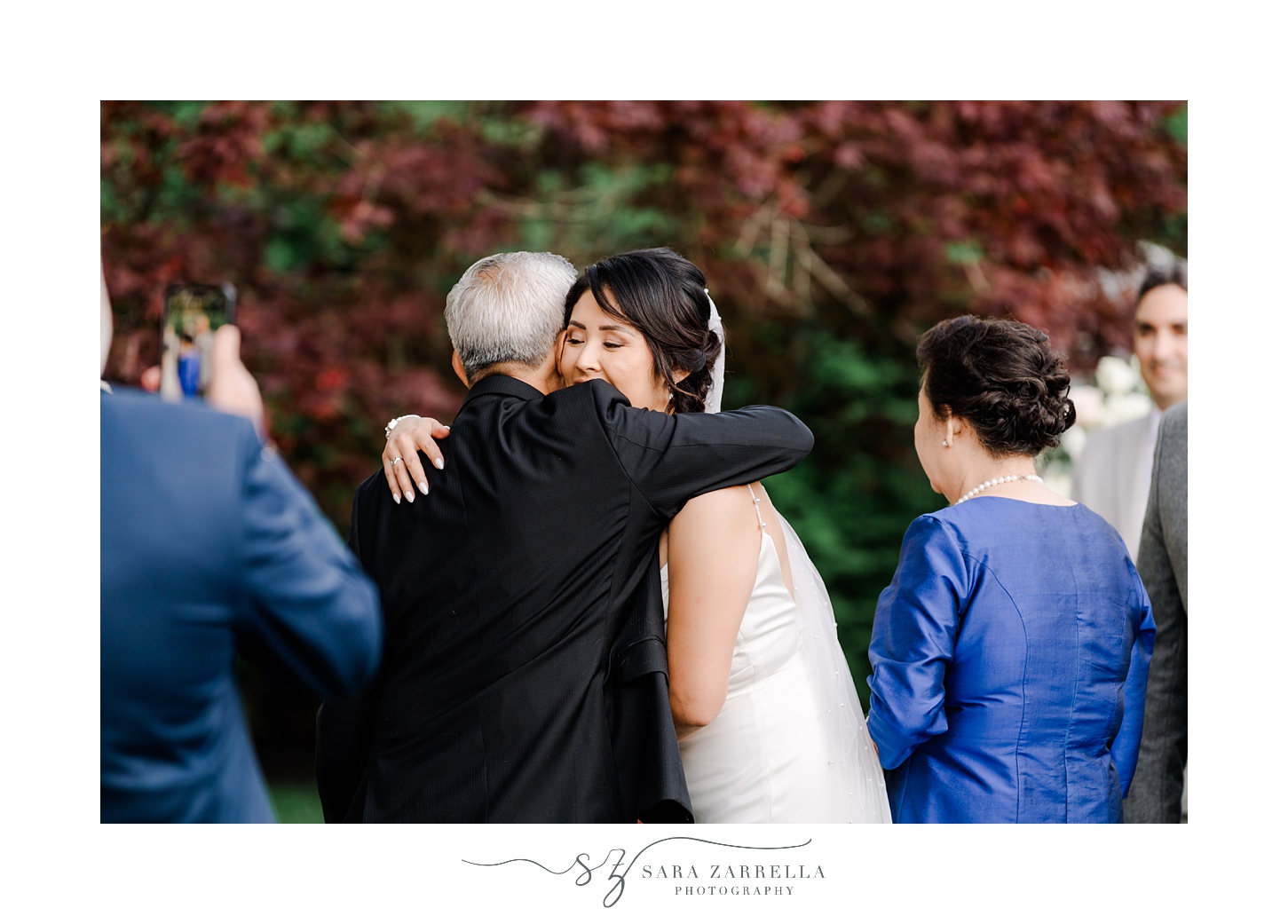 bride hugs father during backyard wedding ceremony in Cranston RI
