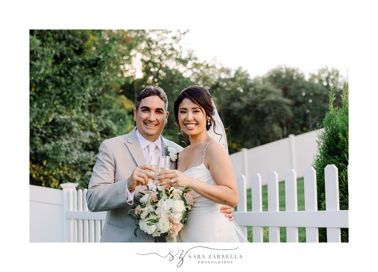 bride and groom toast with champagne after backyard wedding ceremony in Cranston RI