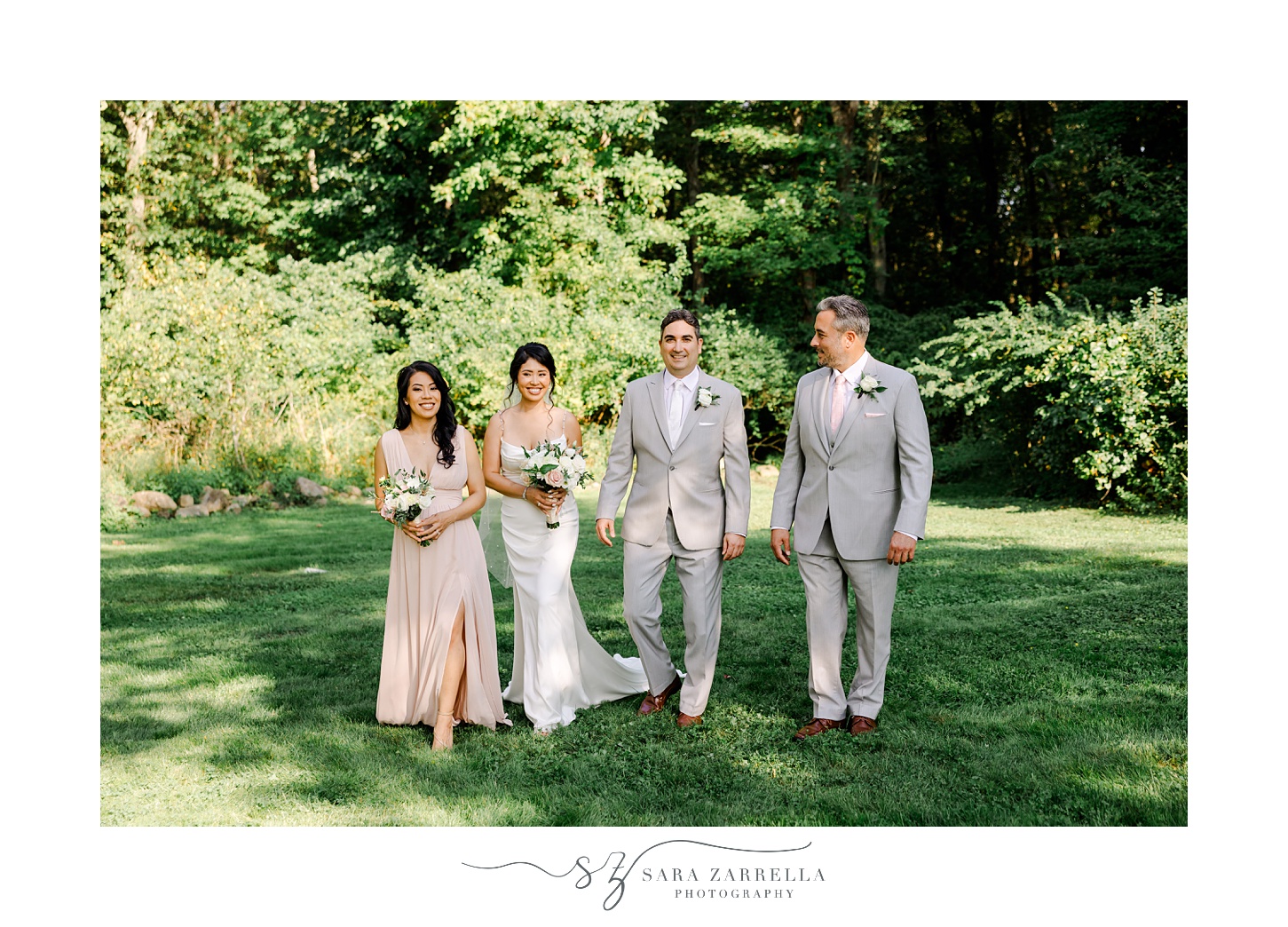 bride and groom walk with wedding party on lawn during backyard wedding in Cranston RI
