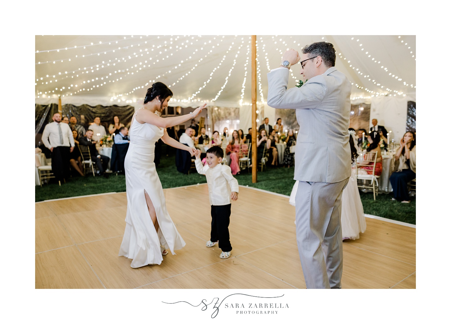 bride and groom dance with kids during tented reception for backyard wedding in Cranston RI