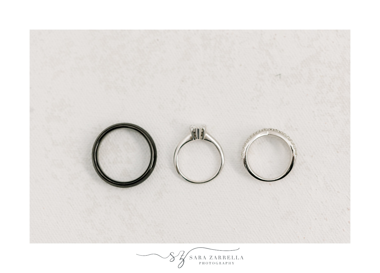 three wedding bands on marbled surface for bride's prep