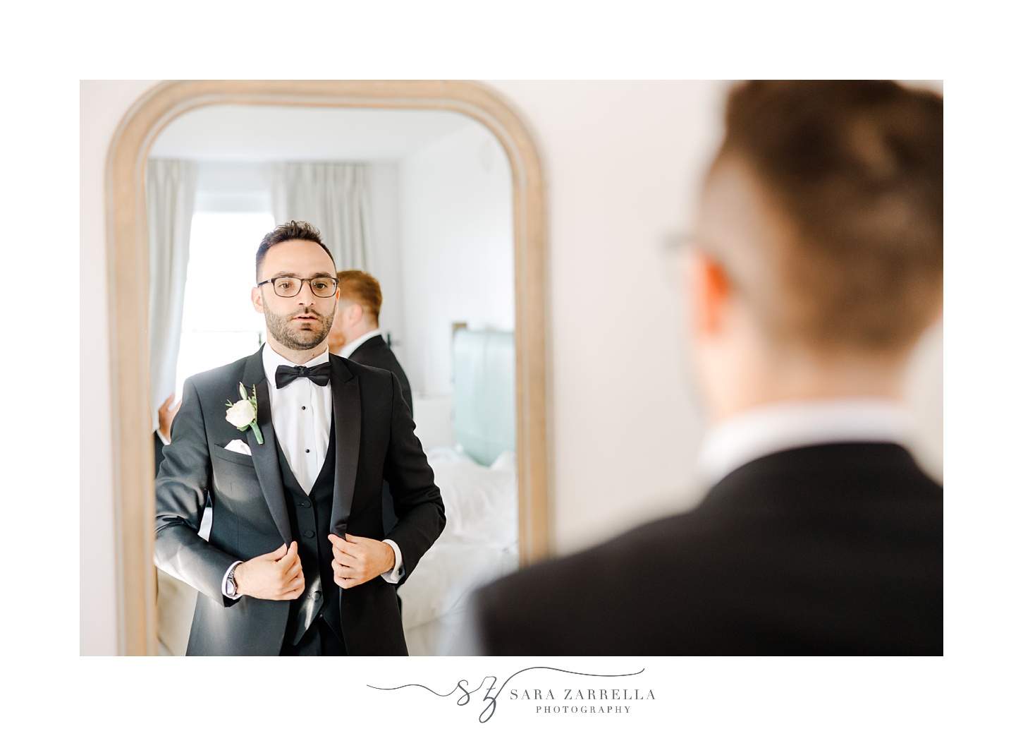 groom buttons up suit jacket in mirror reflection during prep at Shepard's Run
