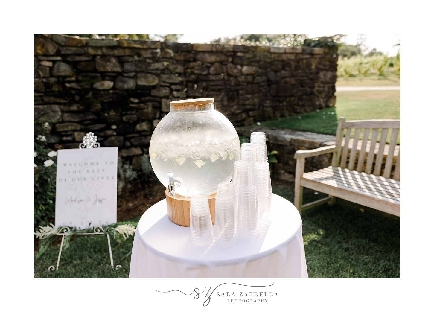 water table with cups for guests and welcome sign for ceremony in the garden at Shepard's Run