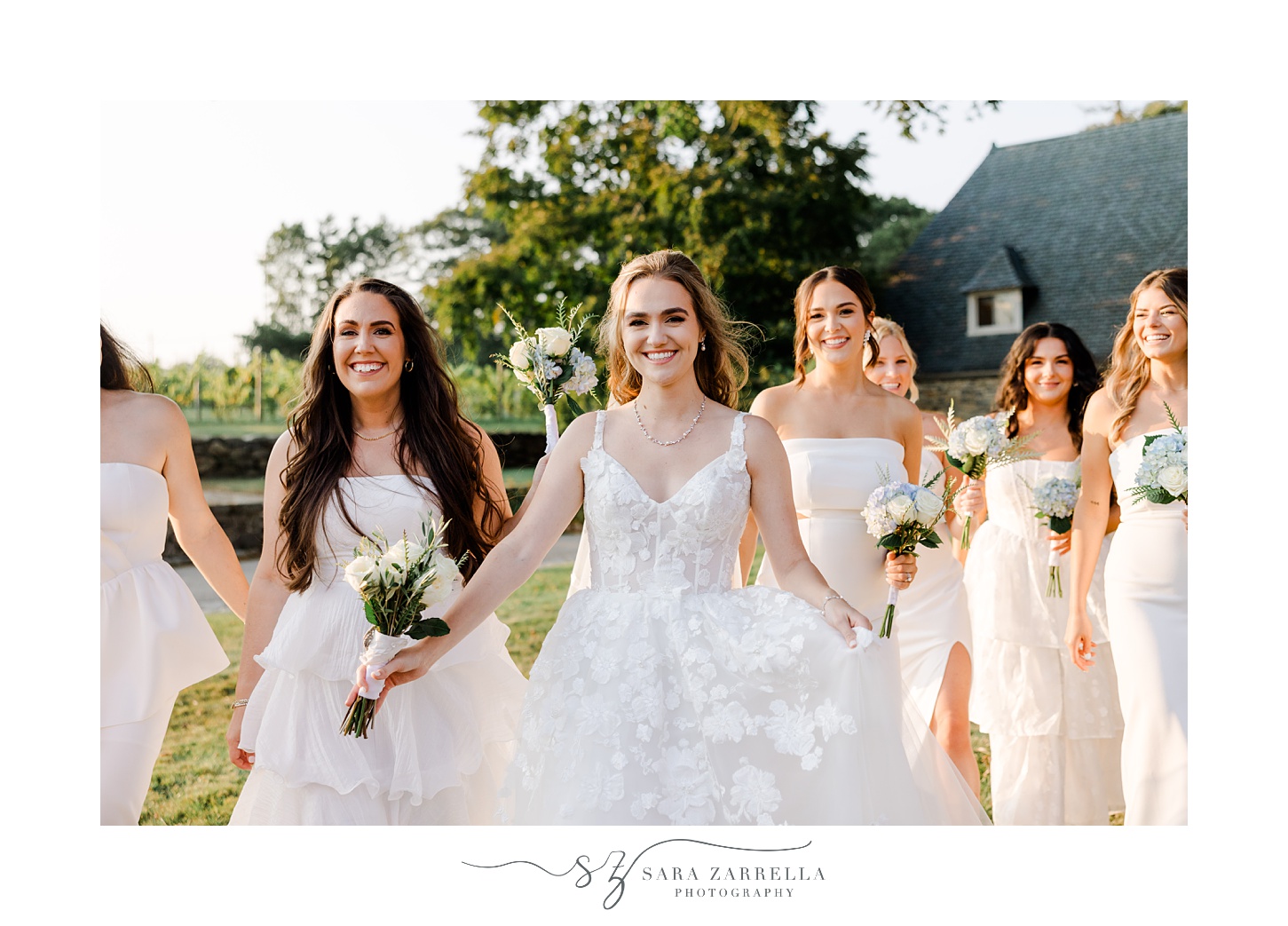bride walks with bridesmaids in mismatched gowns