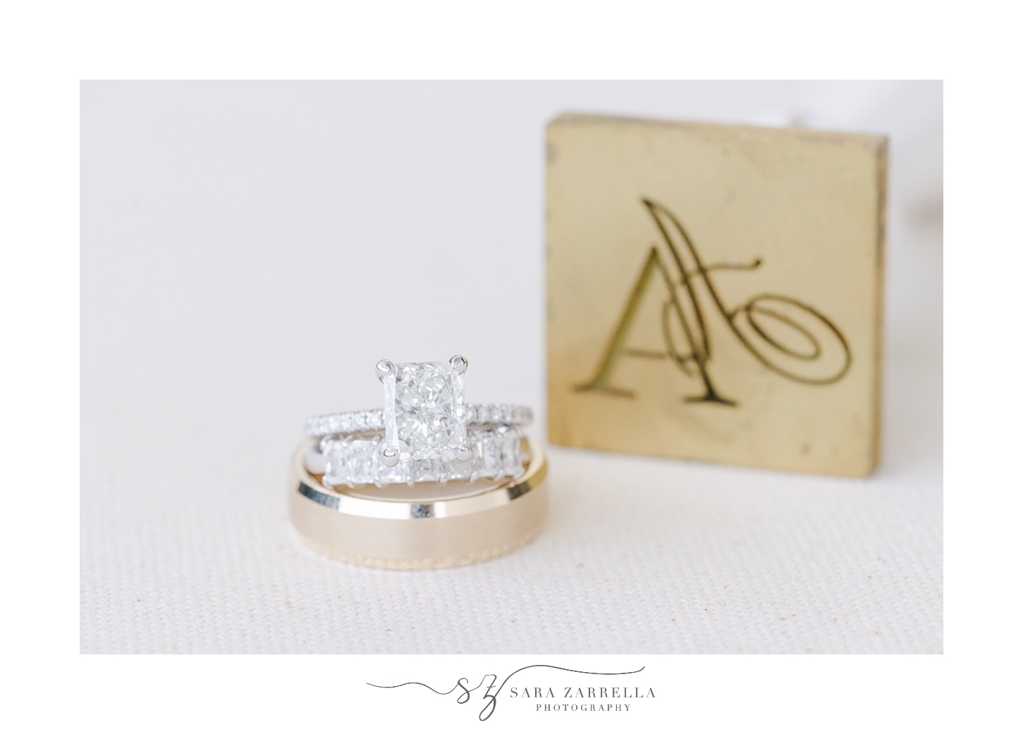 gold wedding bands stacked in front of custom ring box