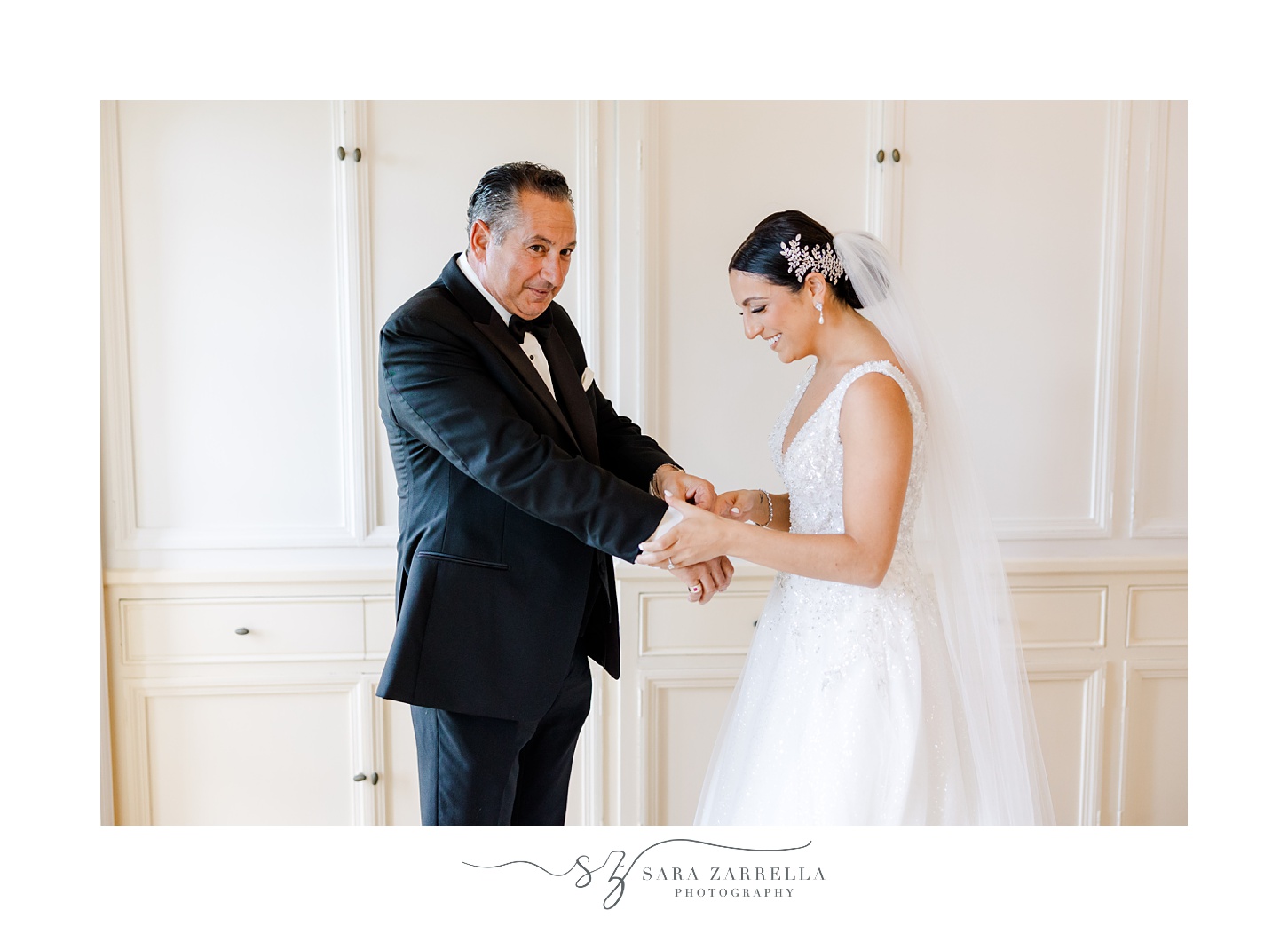 bride looks down at dad's cufflinks during first look in Rhode Island