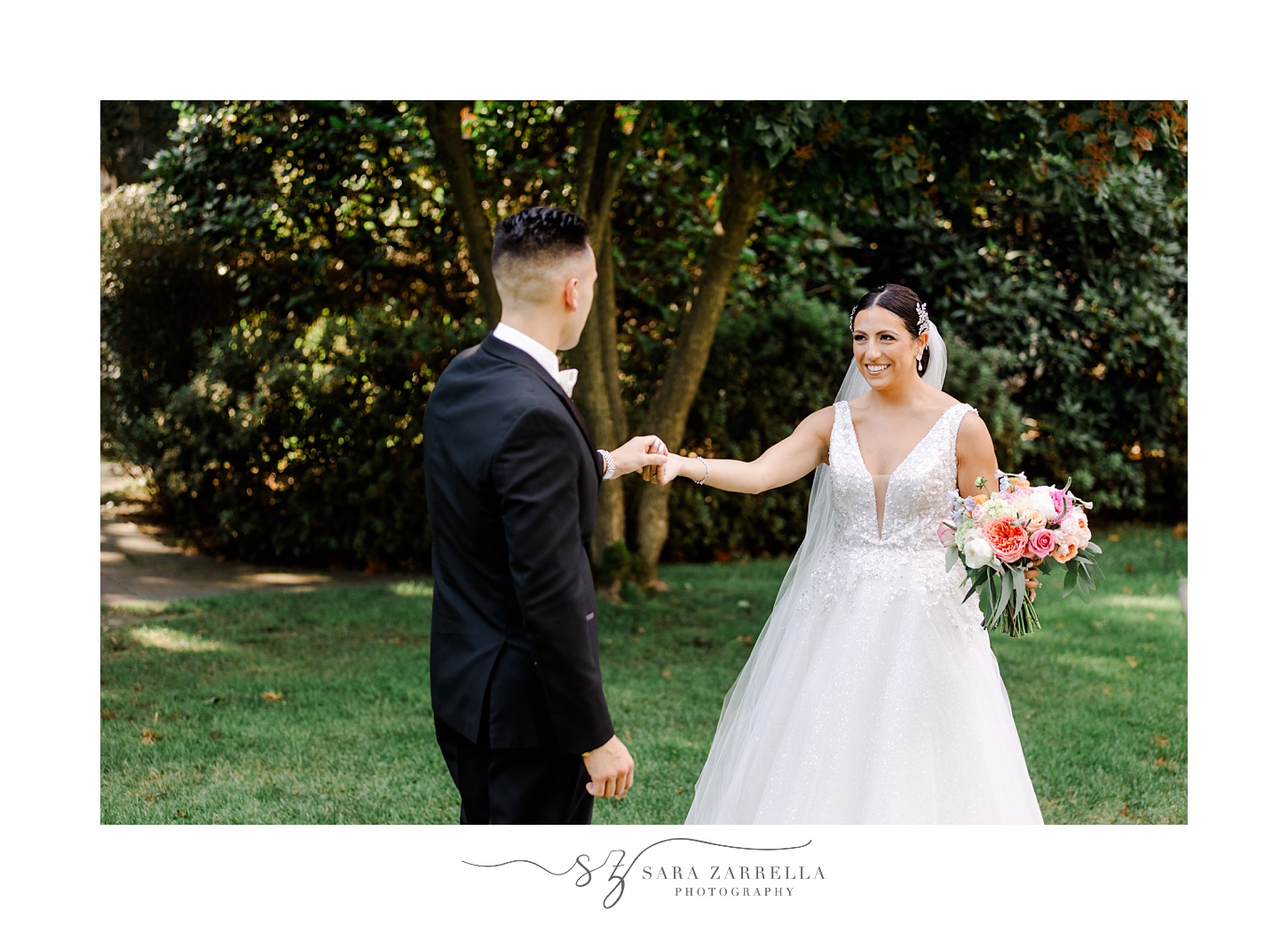 groom twirls bride out looking at wedding dress on lawn at Glen Manor House