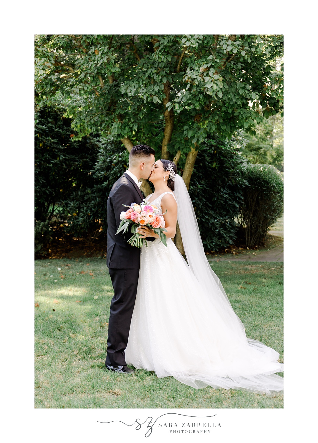 bride and groom kiss on lawn at Glen Manor House