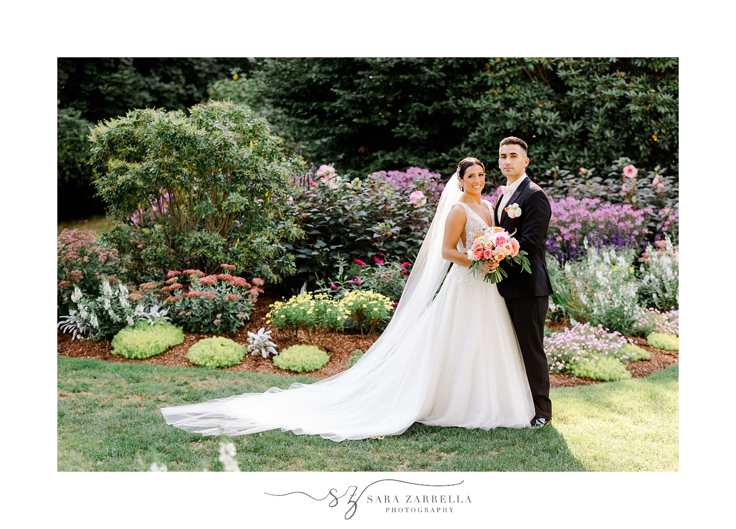bride and groom hug in front of gardens at Glen Manor House