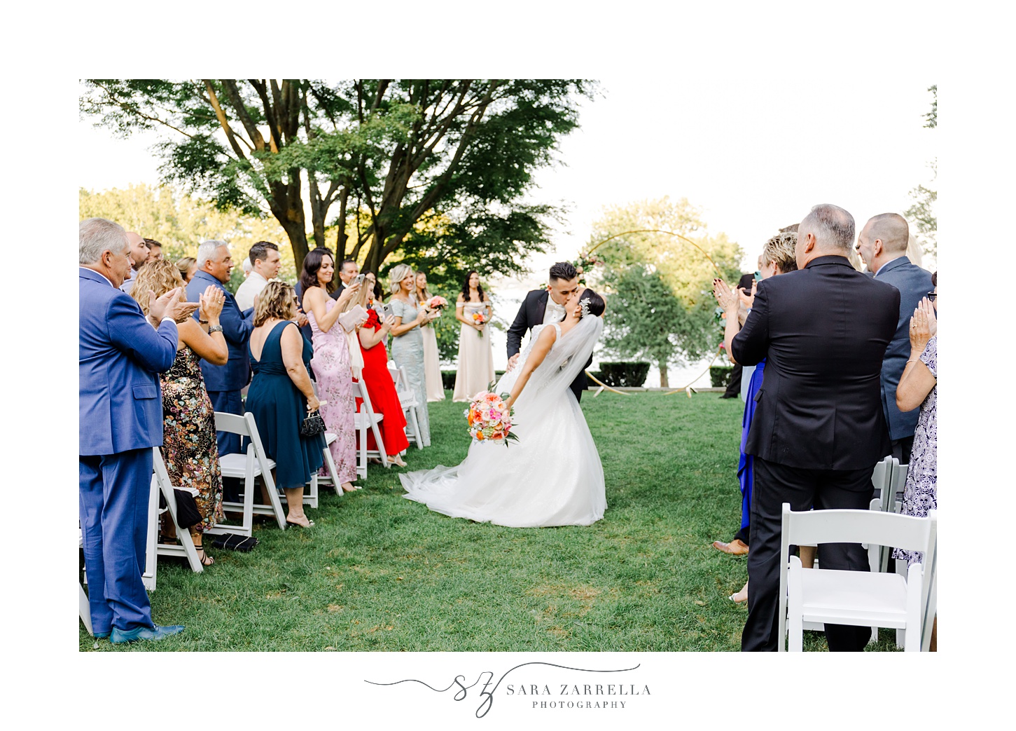 bride and groom kiss in the aisle after ceremony on the lawn at Glen Manor House