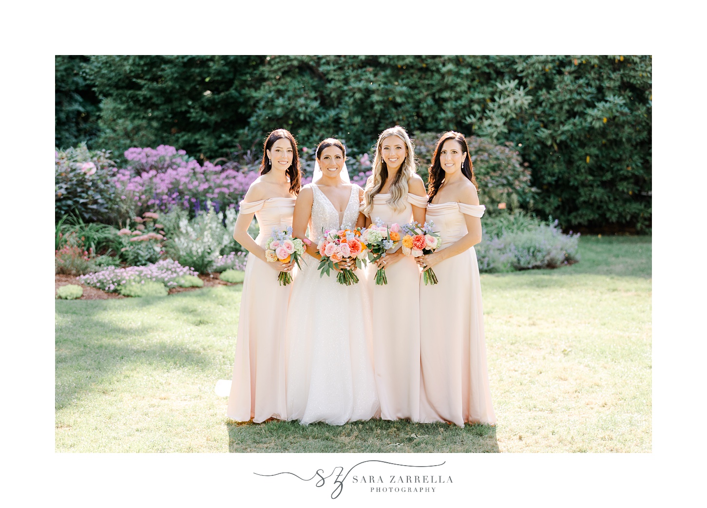 bride and bridesmaids in light pink gowns on lawn at Glen Manor House