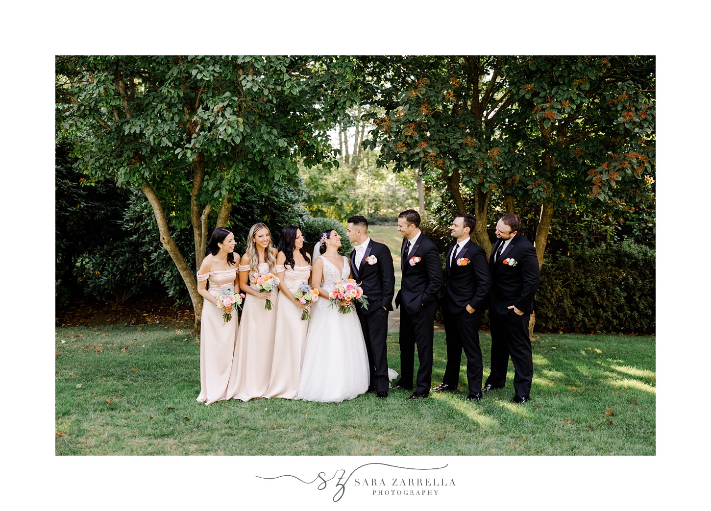 bride and groom stand together on lawn with wedding party on the lawn at Glen Manor House