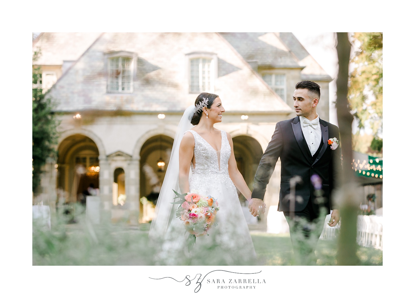 bride and groom walk on lawn at Glen Manor House with tall grass in the front of the photo