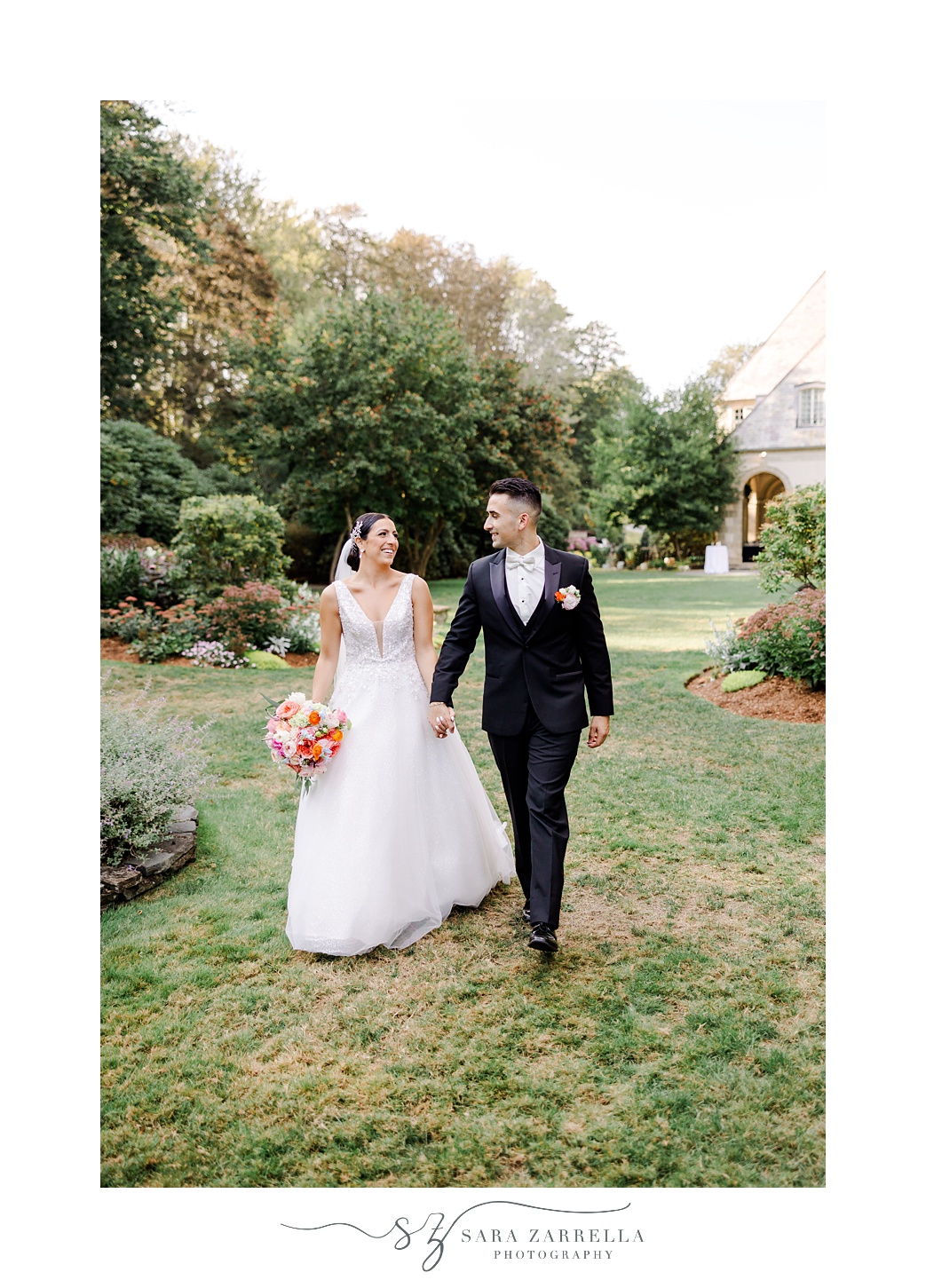 bride and groom hold hands walking on patio at Glen Manor House
