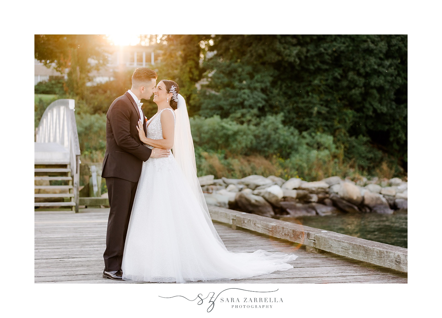 bride and groom kiss on wooden dock at Glen Manor House