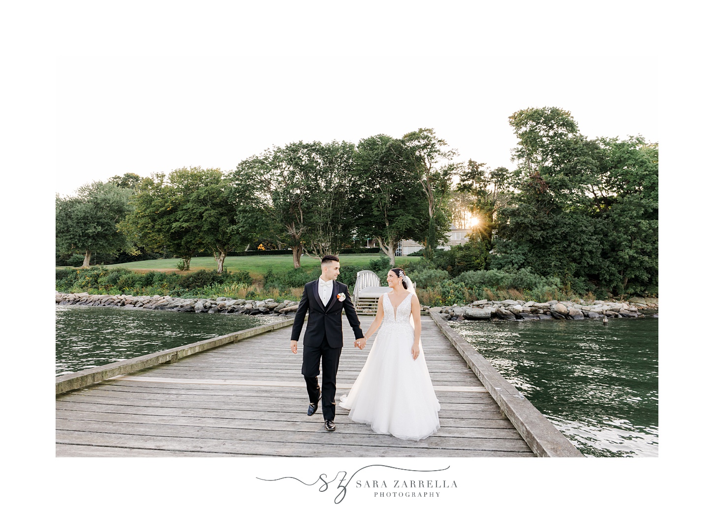 bride and groom hold hands walking on wooden dock at Glen Manor House