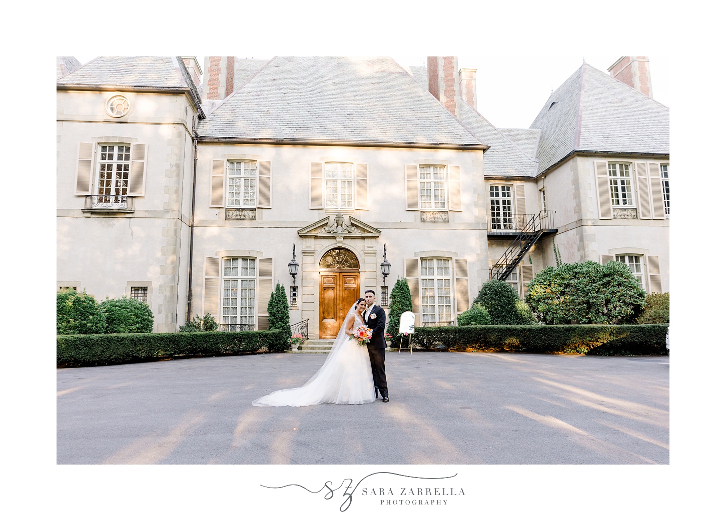 newlyweds stand on driveway outside Glen Manor House