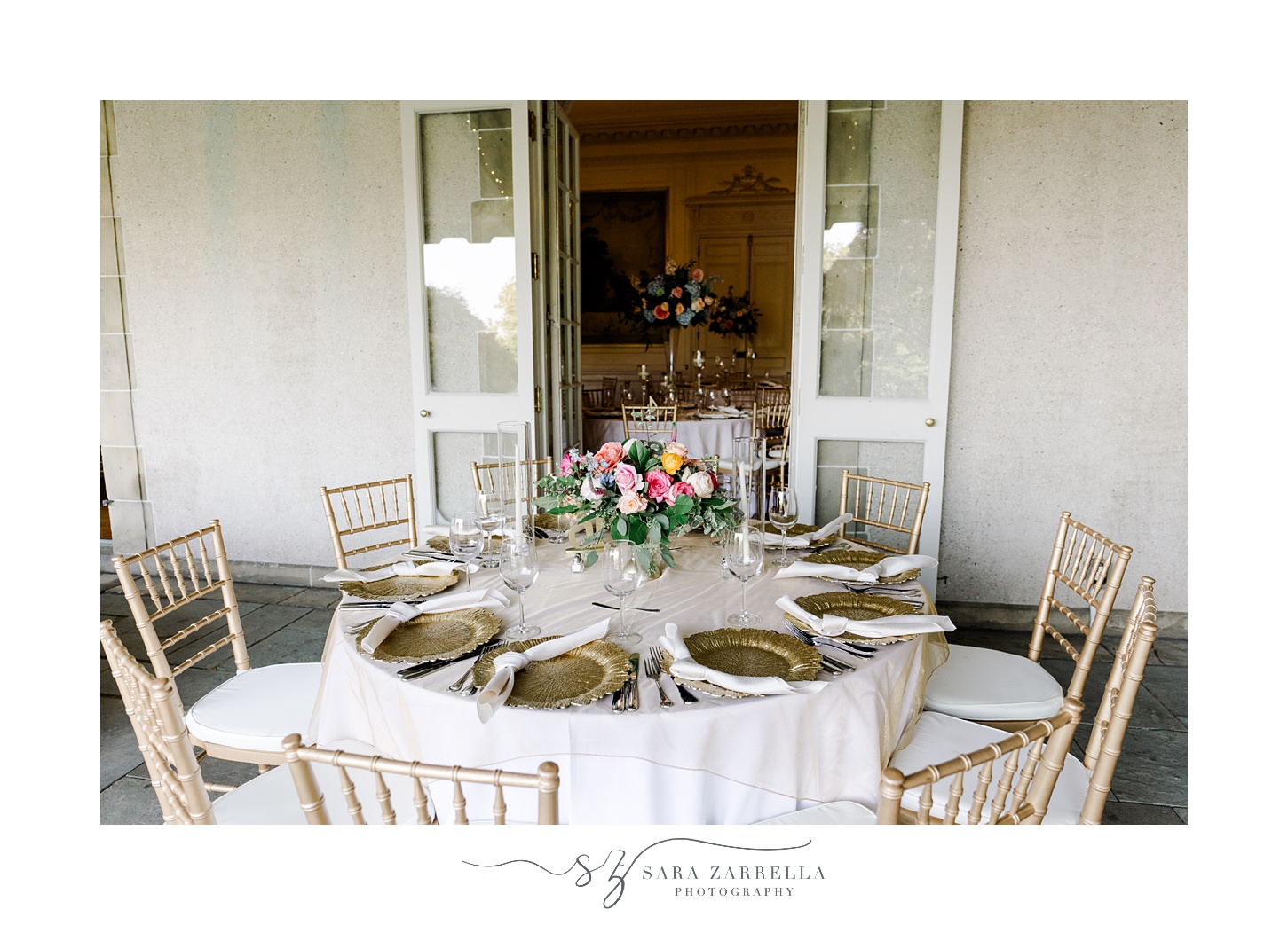 place setting with gold rimmed plates for English garden inspired wedding reception