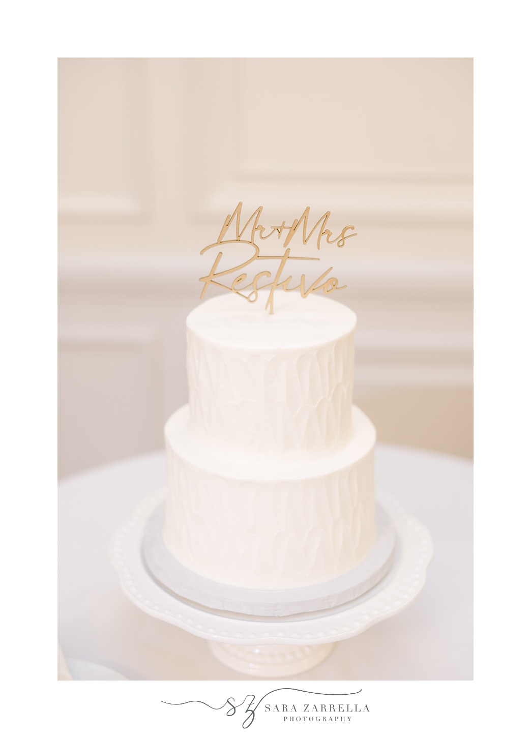 tiered wedding cake with gold topper