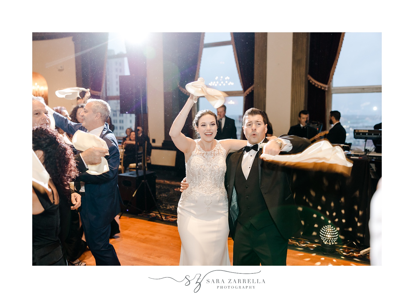 bride and groom twirl napkins with guests during wedding reception in Providence RI