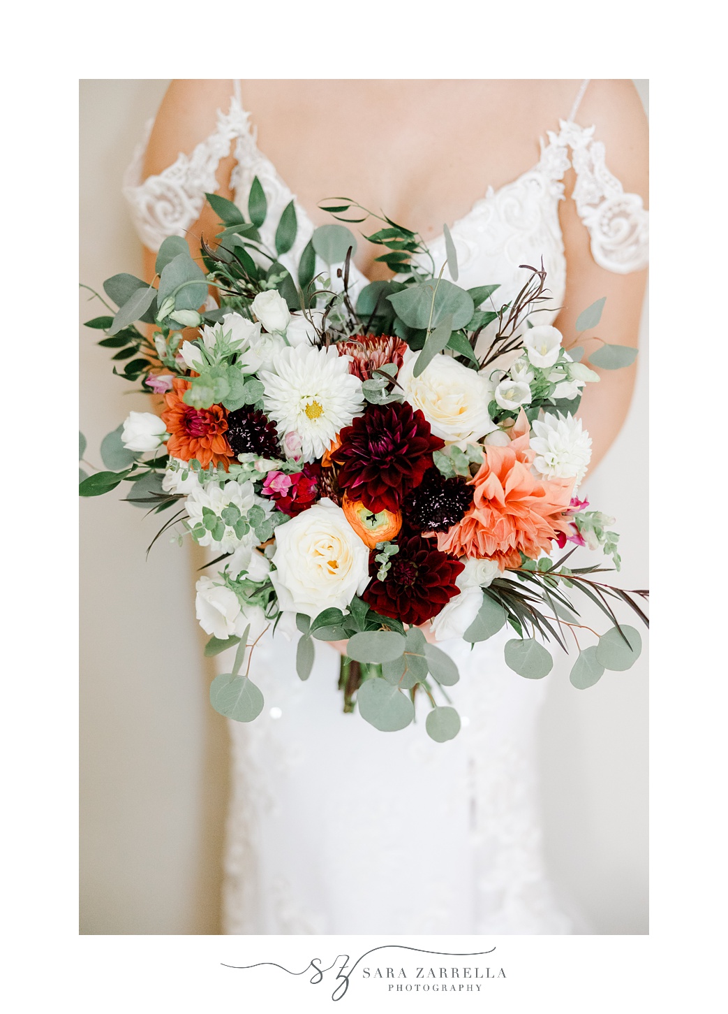 bouquet of fall wedding flowers held inside RI home