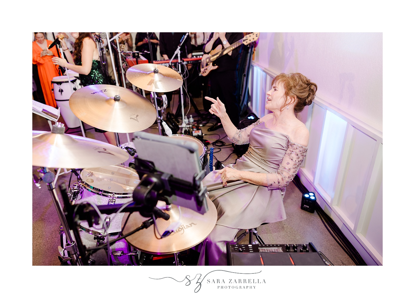 mother plays drums during during South Kingstown RI wedding reception