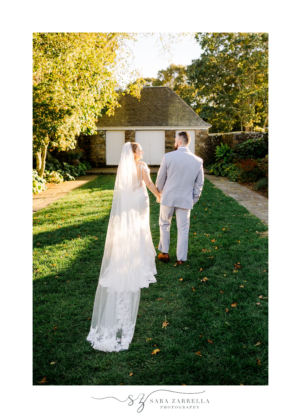 bride and groom hold hands walking on lawn at Shepard's Run