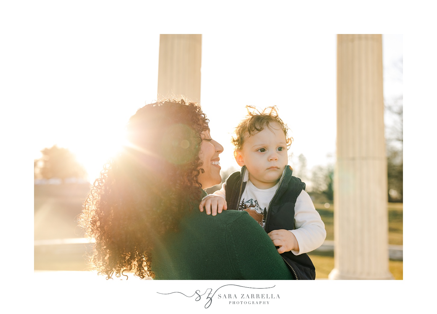 mom hugs son on hip smiling at him during sunrise at Roger Williams Park
